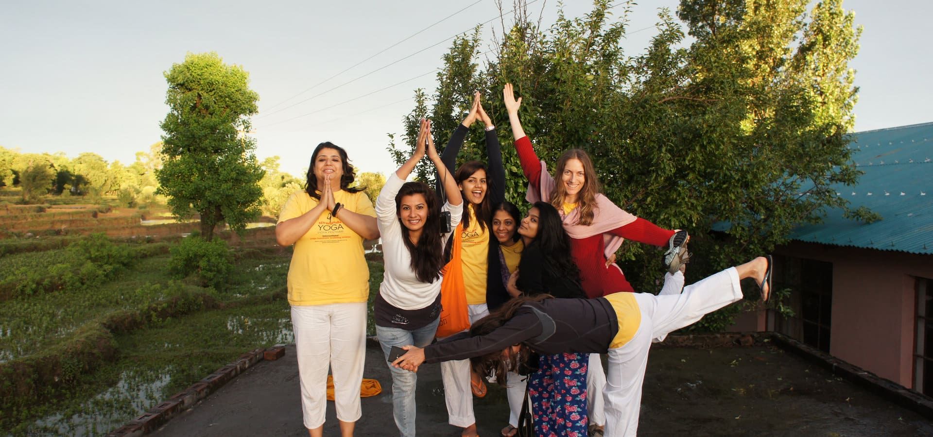 Retreat group practicing asanas outdoors