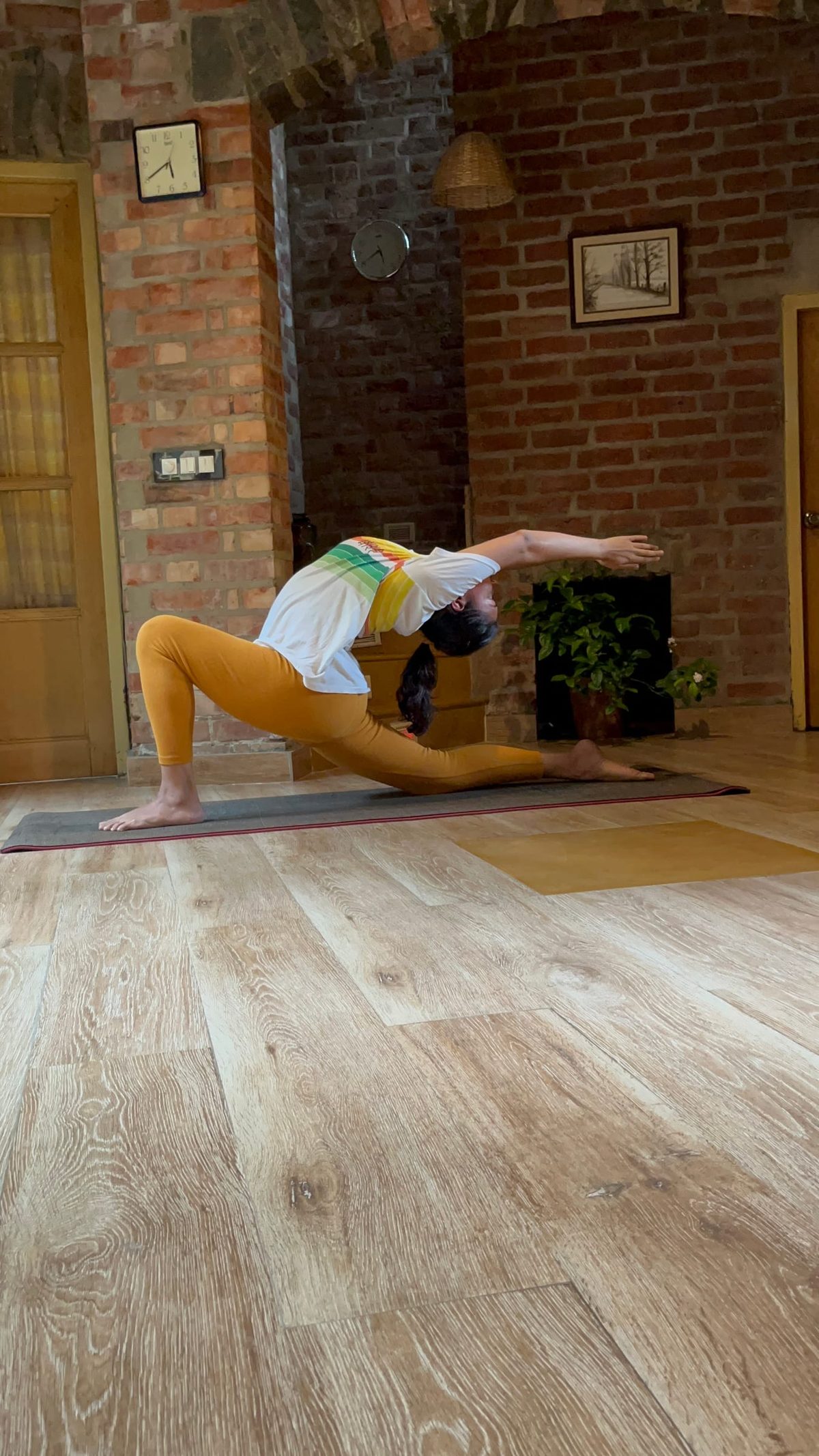 A lunge taken into a backbend, one arm reaching back over the shoulder.
