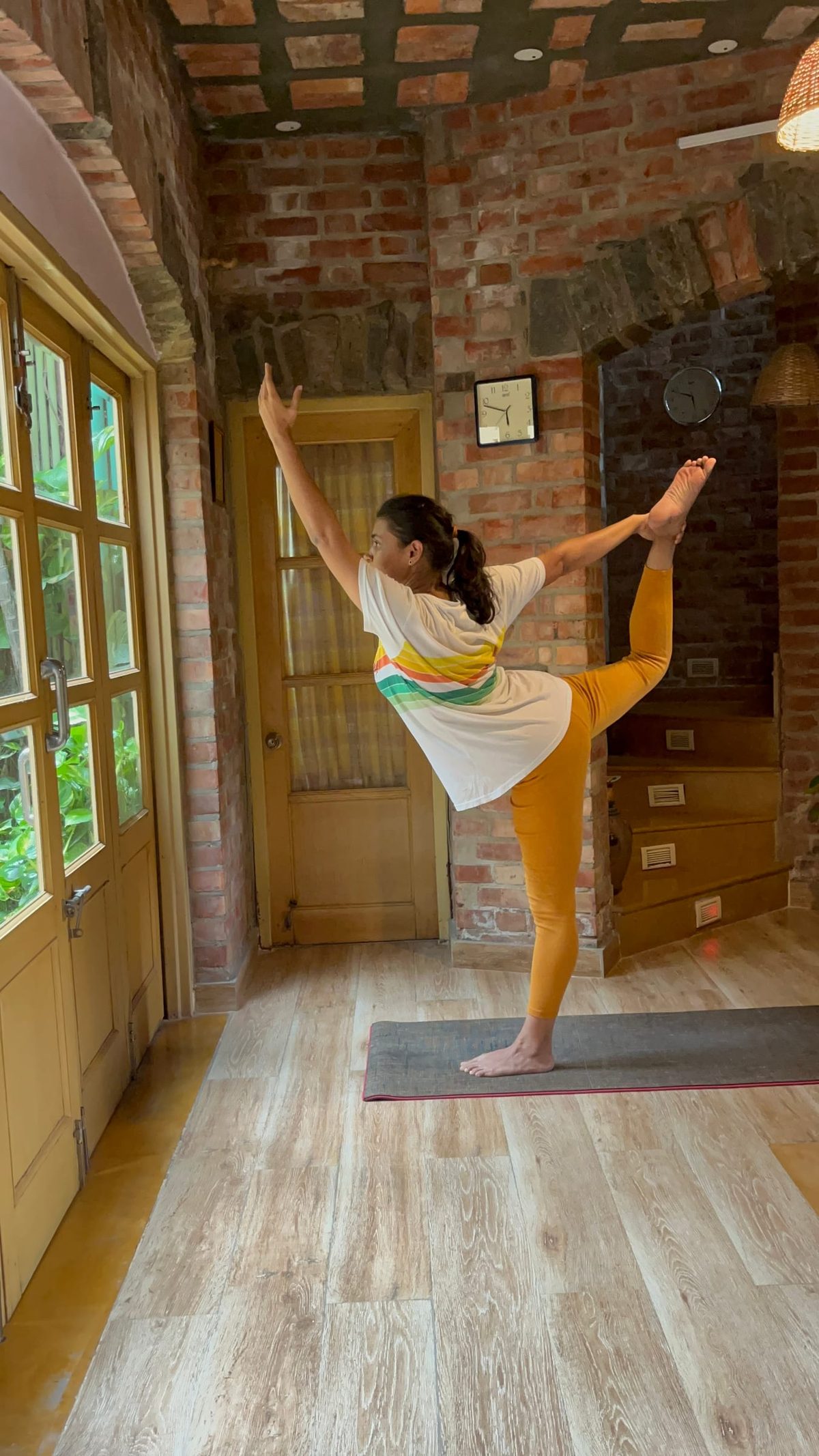 A standing balance on one leg, the lifted foot held high behind.