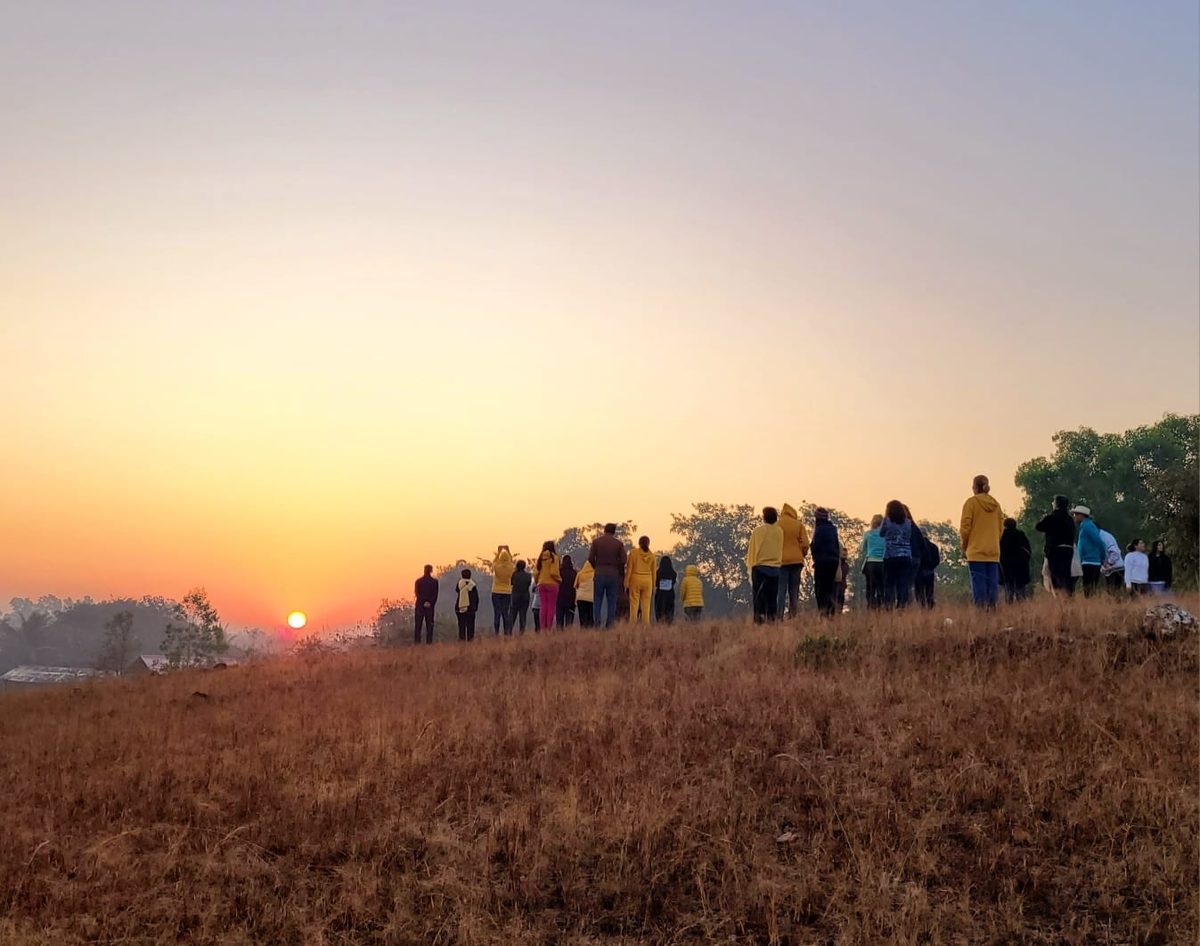 Retreat group walking out to watch the sunrise over open country