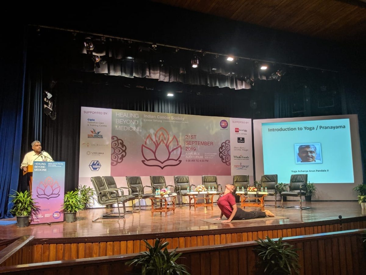 Arun Pandala giving a stage talk introducing yoga and pranayama